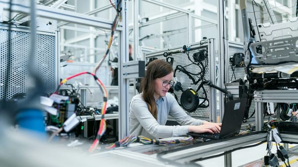 Engineer inspecting a display panel before cleaning