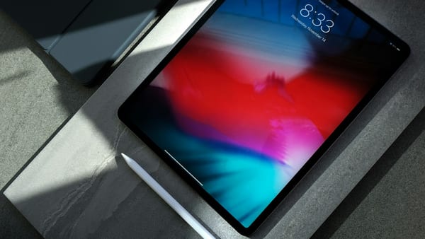 Hand using a tablet touchscreen to verify touch input response