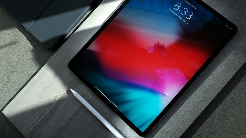Hand using a tablet touchscreen to verify touch input response